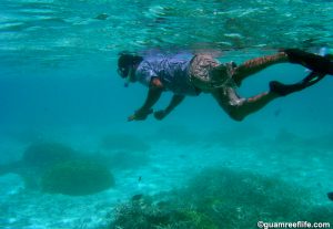 Man fishing illegally in the Tumon Bay Marine Preserve, Guam